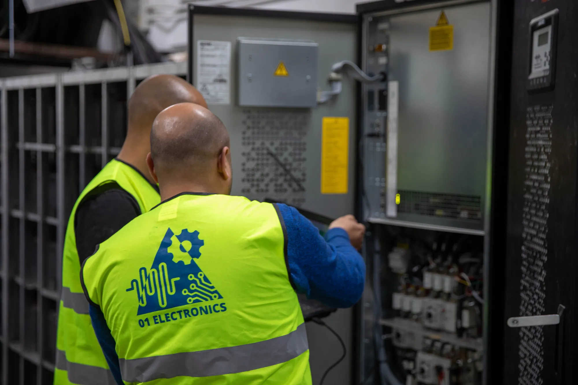 01 Electronics engineers inspecting an open UPS cabinet